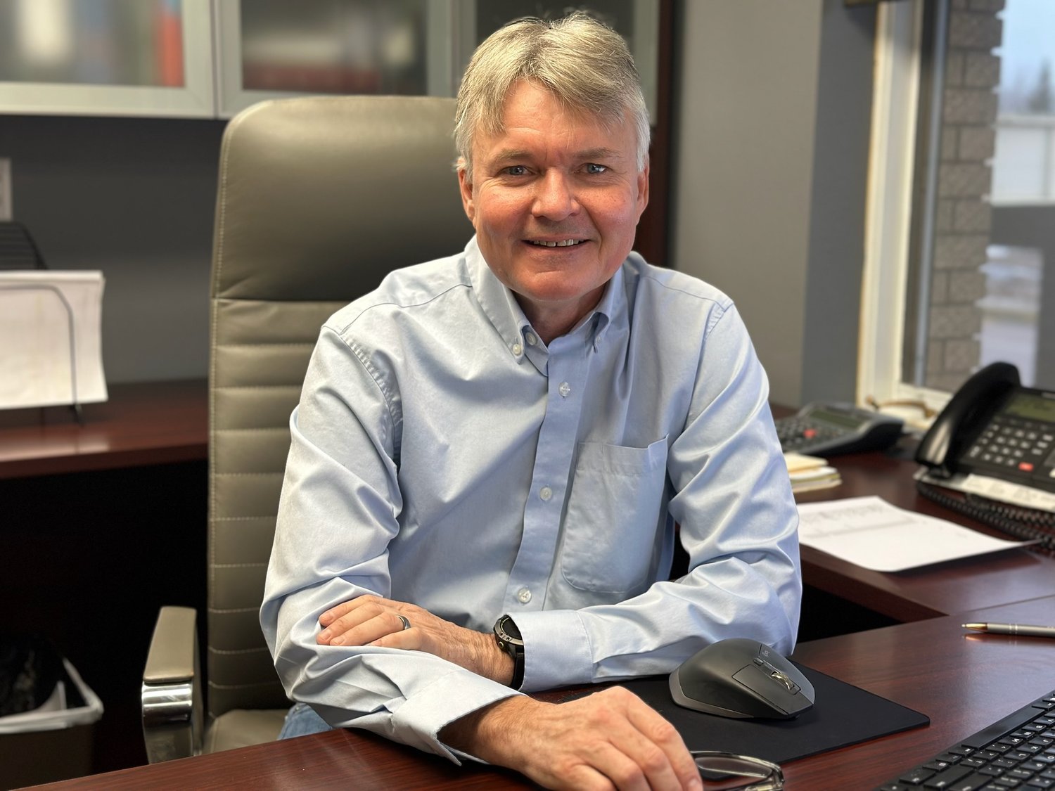 picture of ron pohlman at his desk smiling